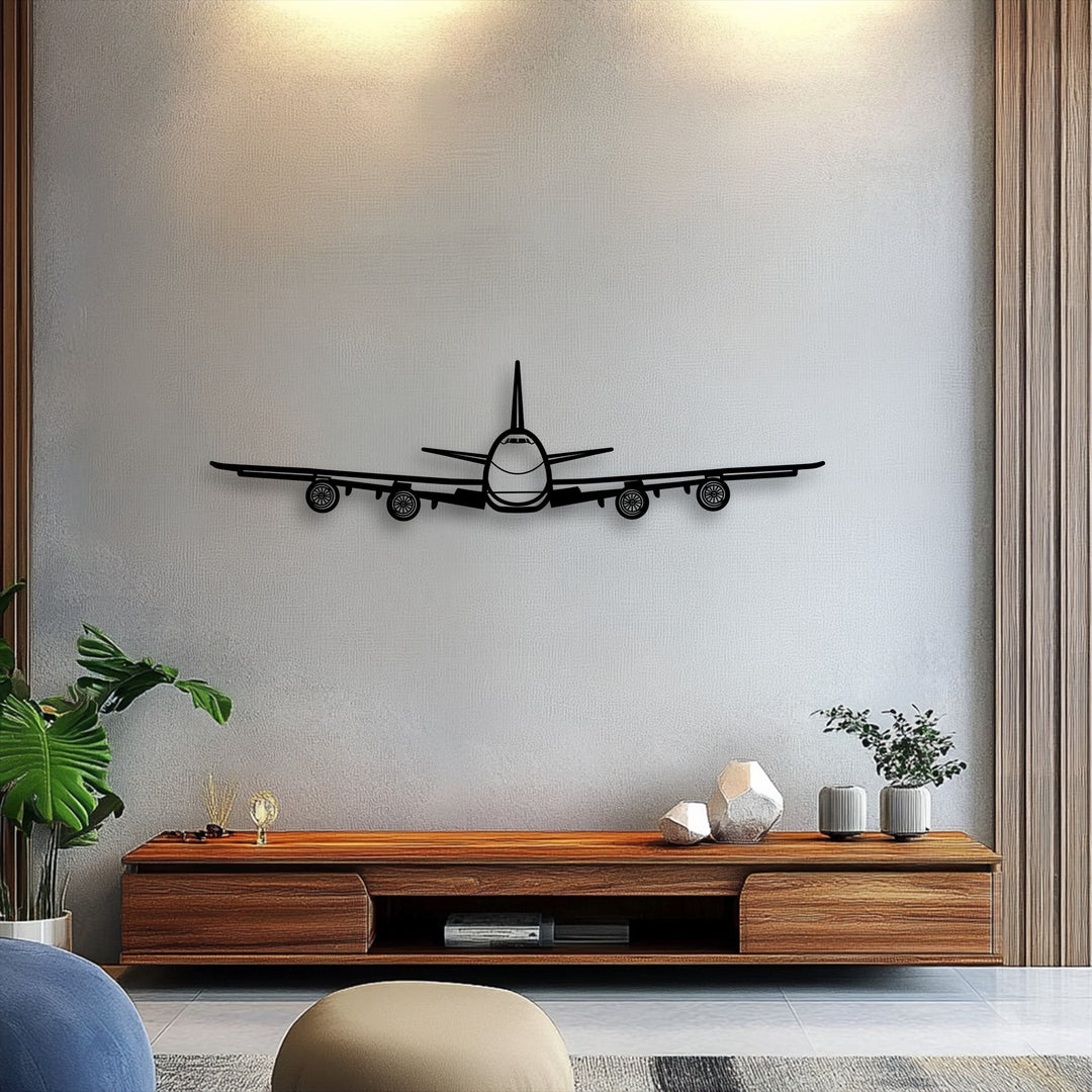 Negative space on the light textured wall defines the sleek airplane front view, a striking piece of decorative metal art aviation wall decor.