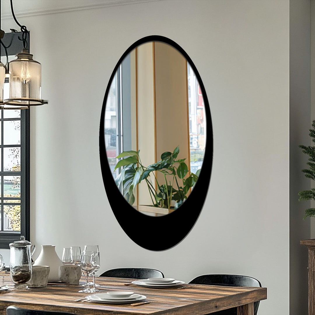 Layered reflections give depth to the framed wall mirror, adding dimension to this sleek, minimal oval floor mirror with its modern black frame.