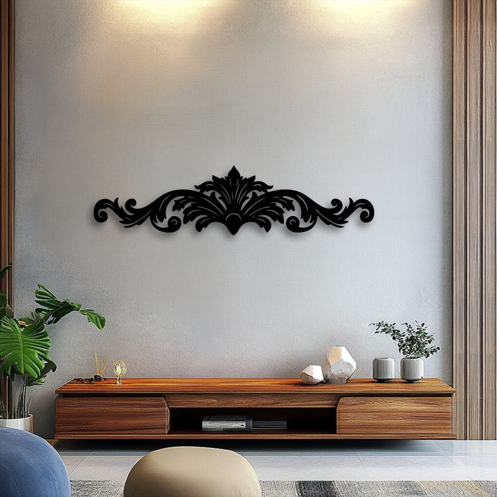 The darkest area showcases an ornate black Regal Flourish ornamental scroll decorative metal art piece centered on a textured light grey wall.