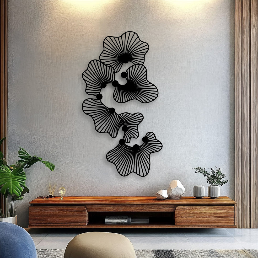 A muted color saturation defines this modern abstract floral metal wall decor, presenting a sleek line flower design against a light wall.