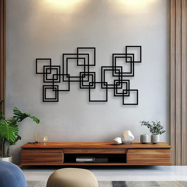 The soft blue cushion contrasts with the crisp lines of the modern interlocking squares decorative metal art above a sleek wooden console table.