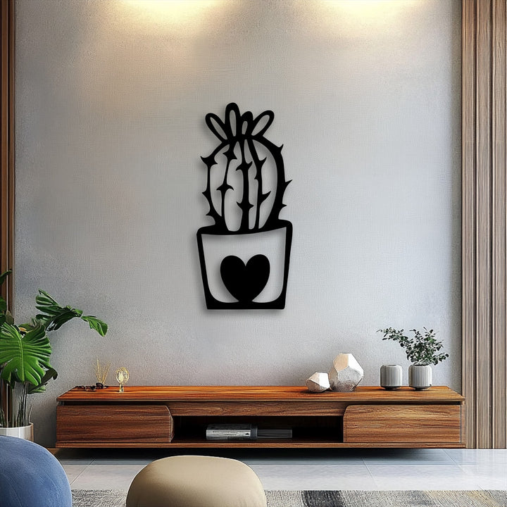 The stillness of a cute cactus metal wall decor with a heart pot design on a textured light gray wall offers a peaceful minimal plant aesthetic.