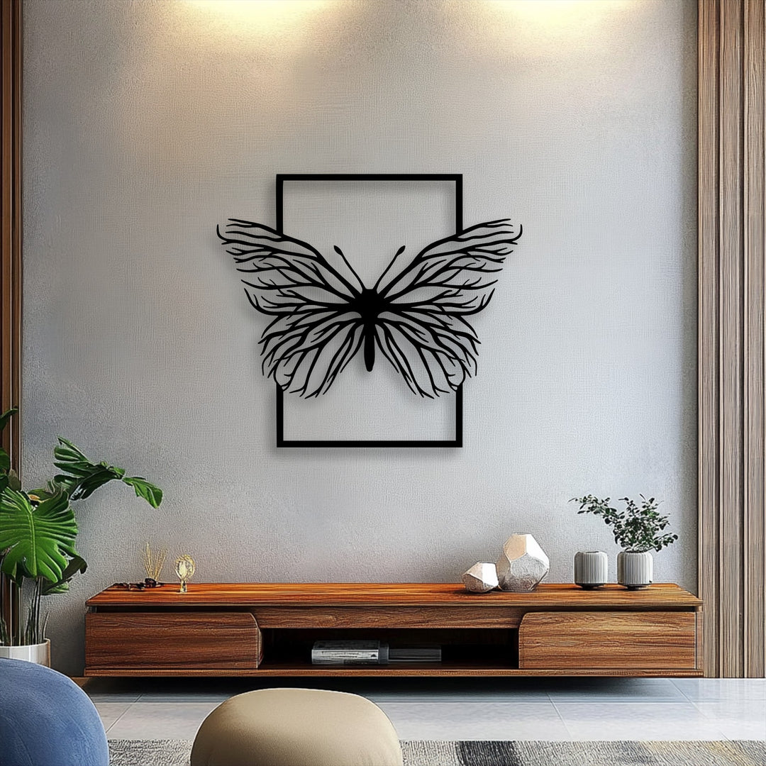 The framed ethereal butterfly metal wall decor presents layered depth with its distinct silhouette artfully highlighted by shadows on the light gray wall.