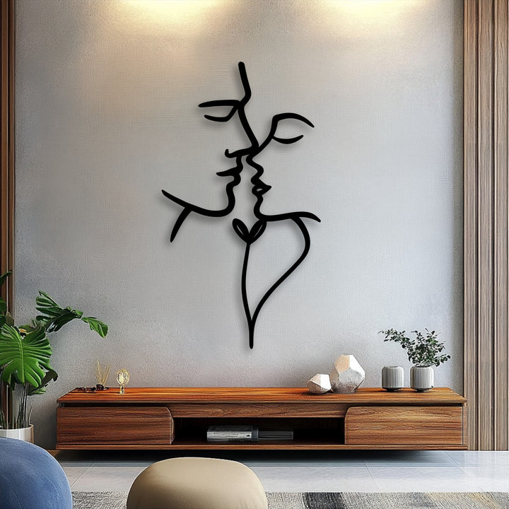 The sleek matte finish of this black Unity Line abstract face metal art for wall emphasizes its minimalist line design.