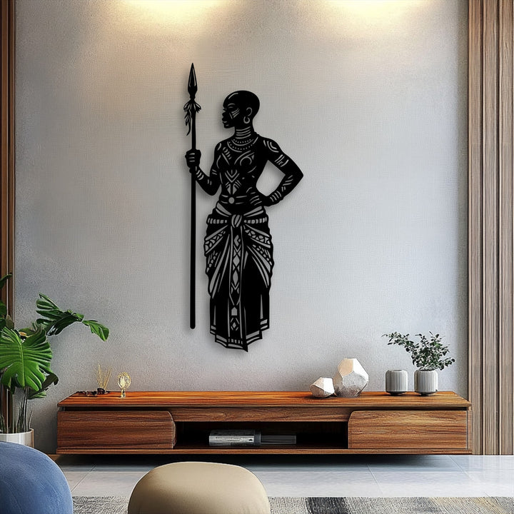Pale grey textured wall features a striking black Tribal African Warrior with Spear metal art for wall above a sleek wooden console.