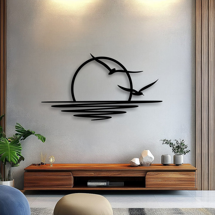 The focal point showcases unique metal wall art depicting a serene coastal sunset with two seagulls flying over minimalist ocean waves.