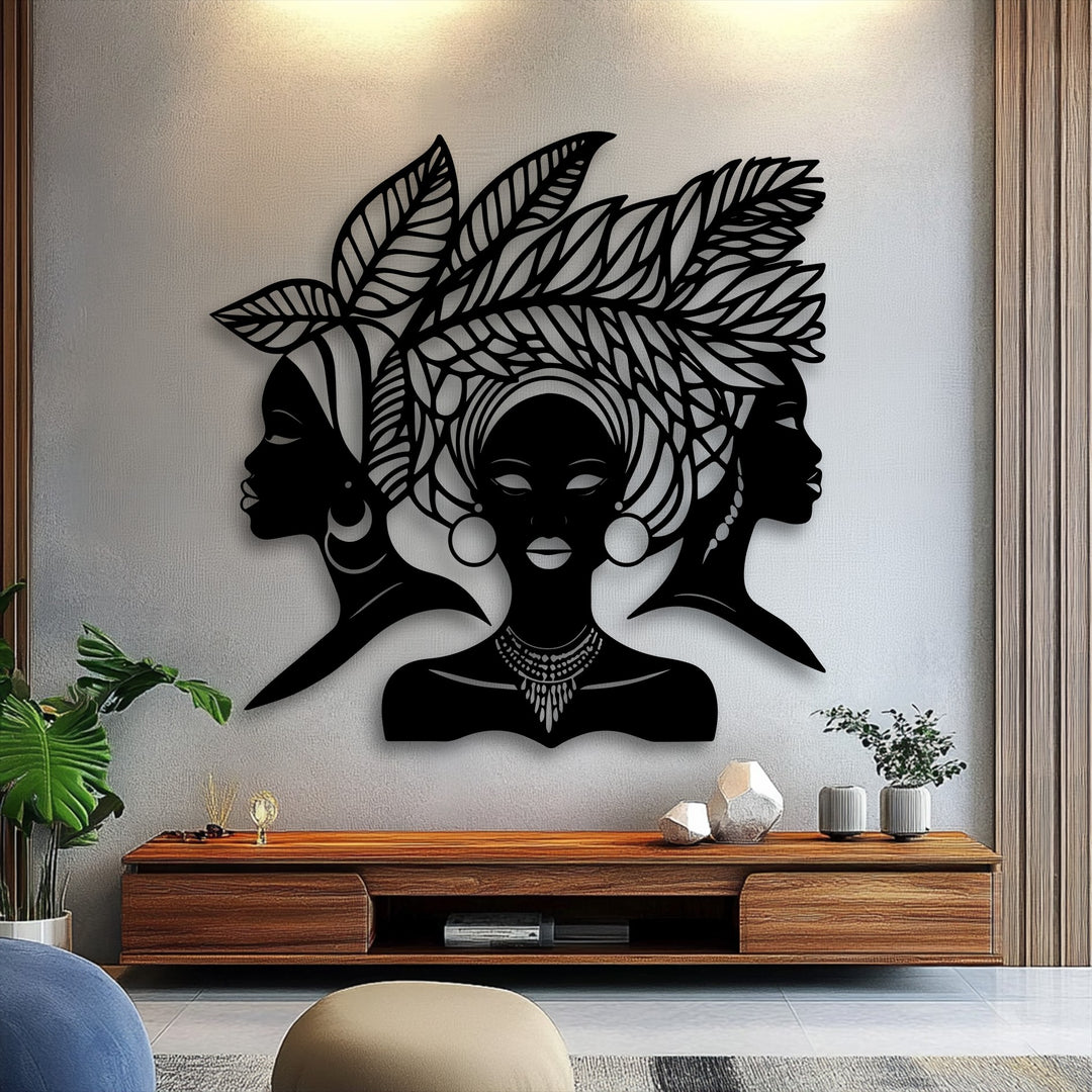The compelling visual rhythm of three African Queen silhouette metal artwork pieces creates a harmonious display of cultural elegance above a console.