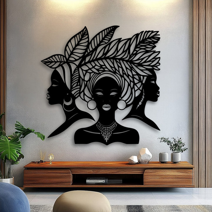 The compelling visual rhythm of three African Queen silhouette metal artwork pieces creates a harmonious display of cultural elegance above a console.