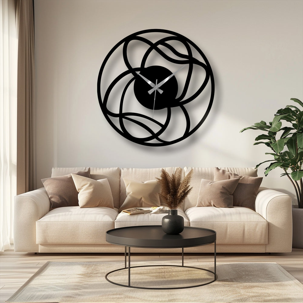 Gentle curves define this decorative metal art clock, its interwoven design adding a modern, abstract touch to any space, especially with soft, inviting pillows.