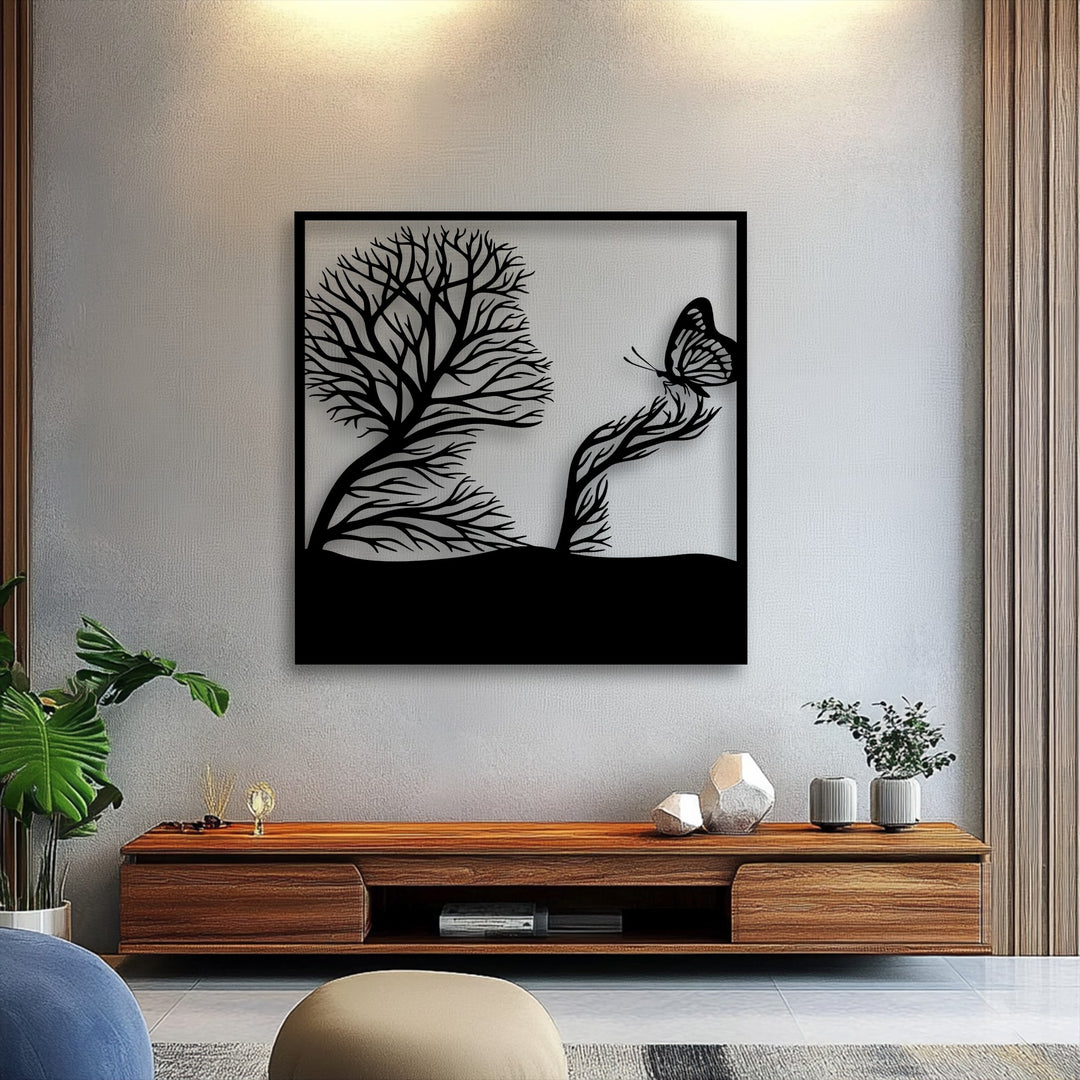 A striking transition from the dark silhouette of the unique metal wall art, portraying a whimsical tree and butterfly, against the subtly lit grey wall.