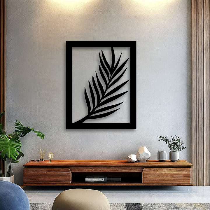 The darkest area distinctly features a bold minimal palm leaf silhouette enclosed in a black frame, forming modern botanical metal artwork.