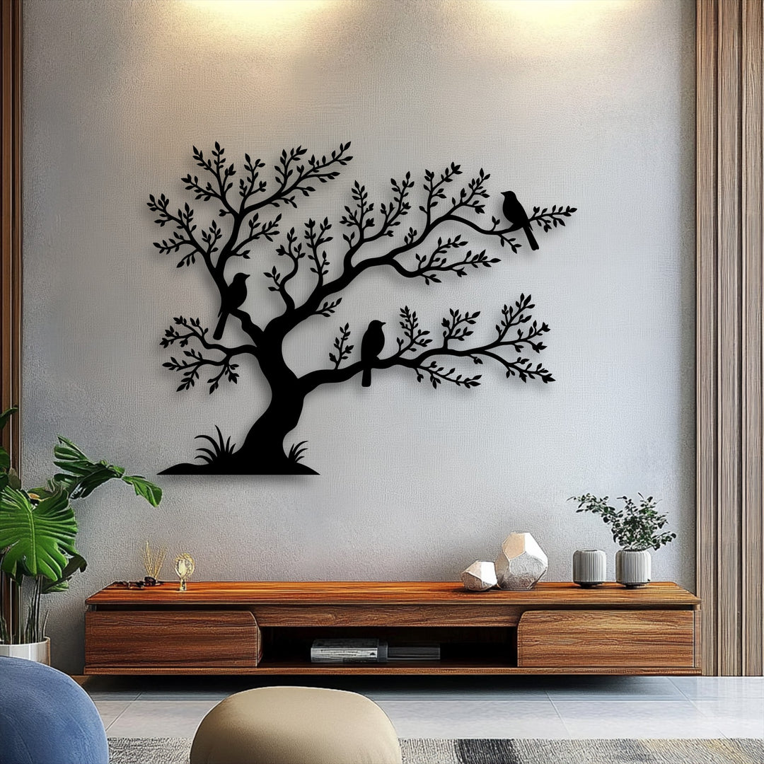 The layered metal art for wall featuring birds on a tree creates a distinct visual depth against the textured wall, complemented by foreground objects.