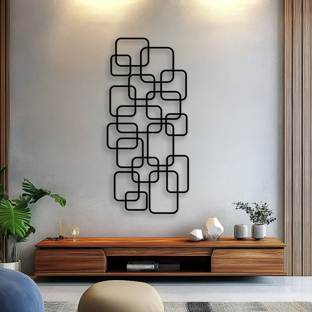 The realistic detail of this geometric metal wall decor reveals precisely contoured interlocking squares with subtle shadows on a textured wall.