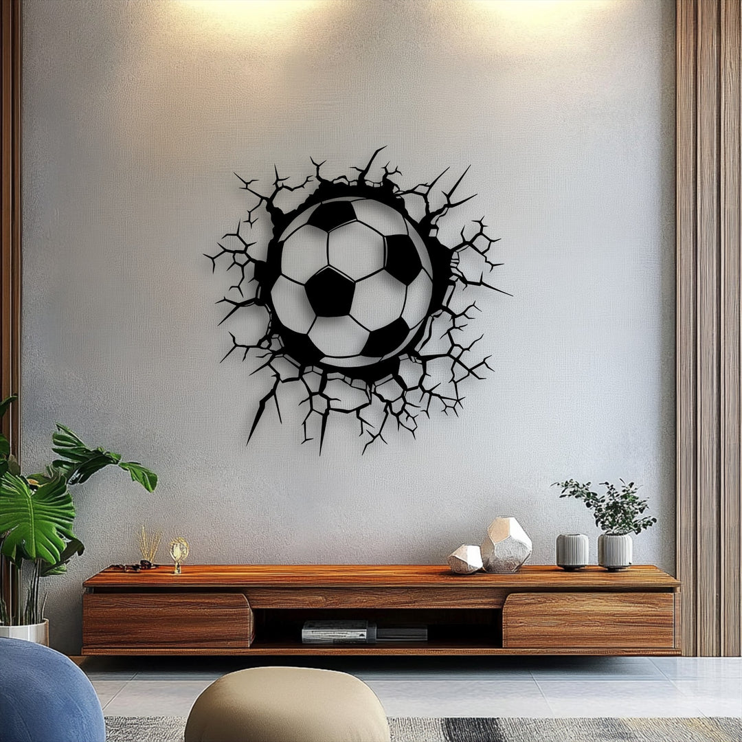 The energetic mood of a modern living space is amplified by the dynamic breaking wall soccer ball metal wall decor.