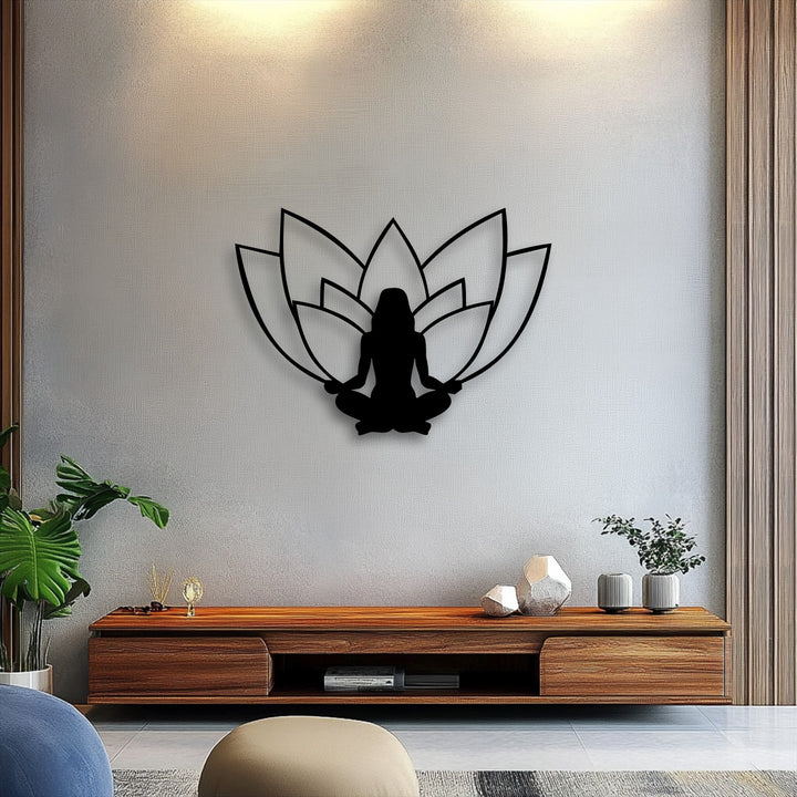 The visible layering effect places the intricate metal artwork of a serene lotus meditation silhouette against a soft textured wall.