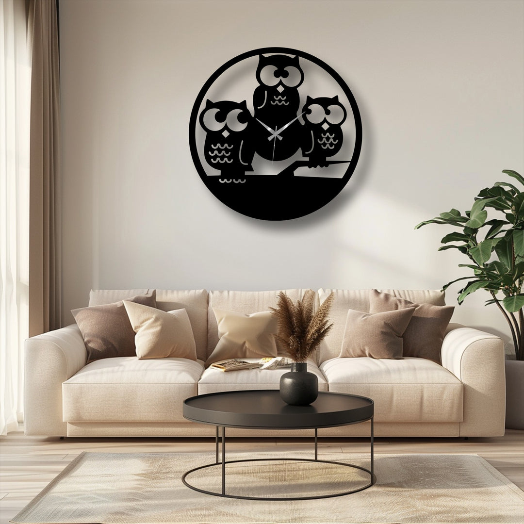 The dominant creamy off-white backdrop highlights the captivating Three Owls Silhouette Metal Wall Clock, a perfect piece of decorative metal art.