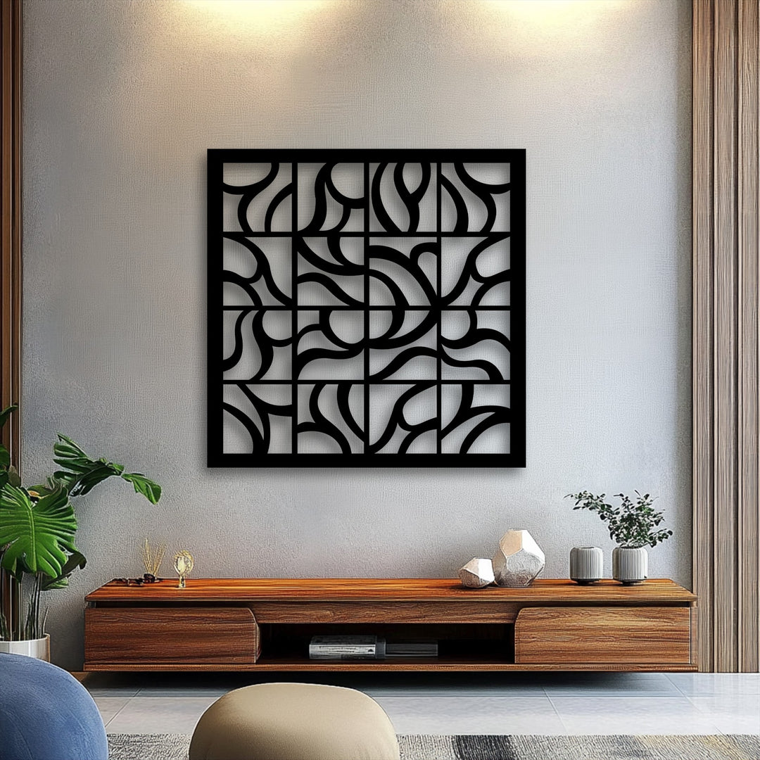 The realistic detail showcases the intricate curves and sharp lines of the black geometric flow grid metal art for wall, mounted against a textured grey wall.