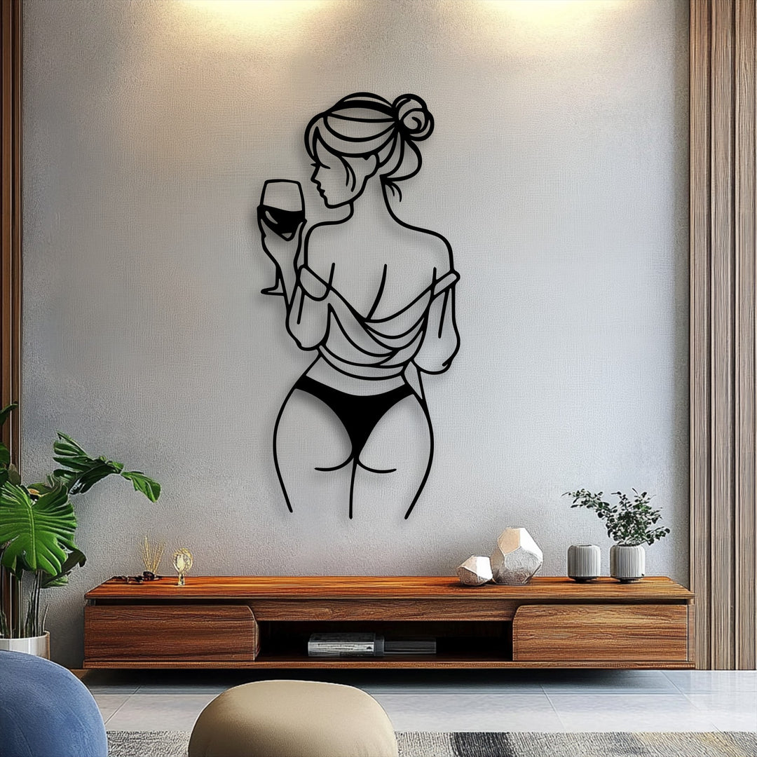 The stillness of the elegant wine moment is captured in this minimalist line art metal wall decor, depicting a woman from behind holding a glass.