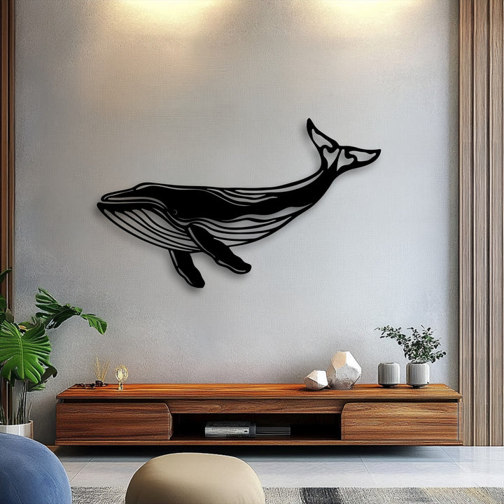 With balanced color saturation, a striking unique metal wall art of a majestic whale silhouette provides a bold focal point above a wooden console.