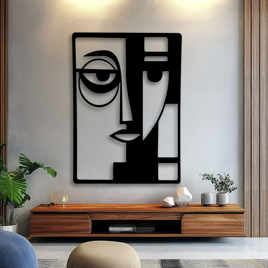 The realistic detail of the modern geometric metal artwork reveals intricate facial forms and sharp lines, casting subtle shadows on the textured wall.