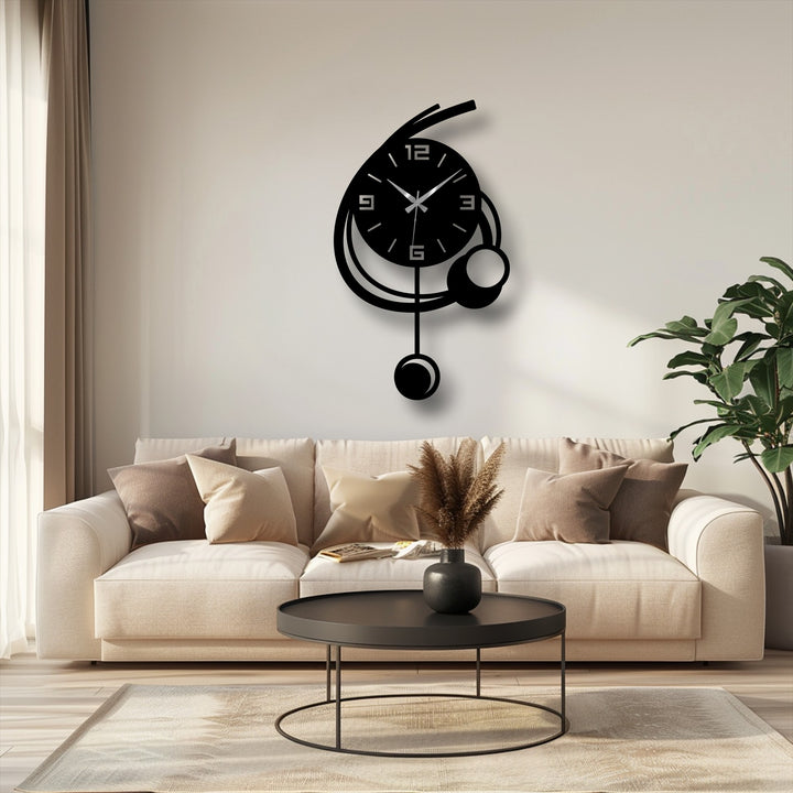 Crafted with durable metal, this modern orbit pendant metal wall clock shows fine detailing as a minimalist geometric metal art for wall clock.