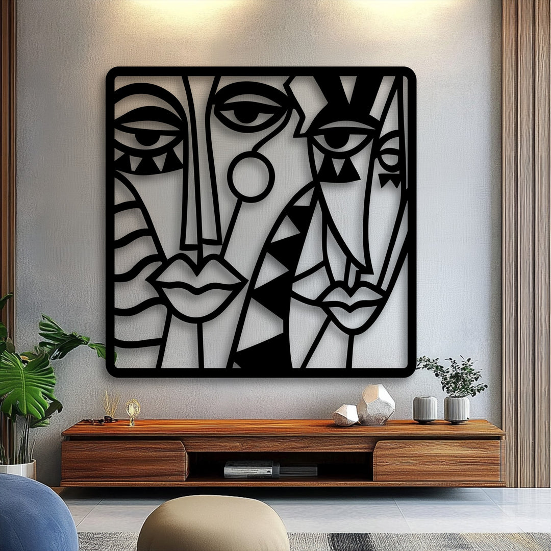 Featuring bold color contrast, the black cubist abstract faces metal art for wall provides a striking visual against the light wall.