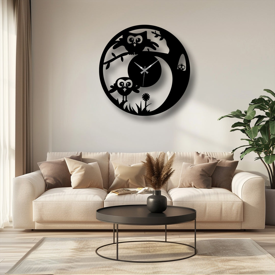 Minimal color saturation enhances the striking details of this black metal wall clock, a piece of decorative metal art depicting a cute owl in a playful nature scene.