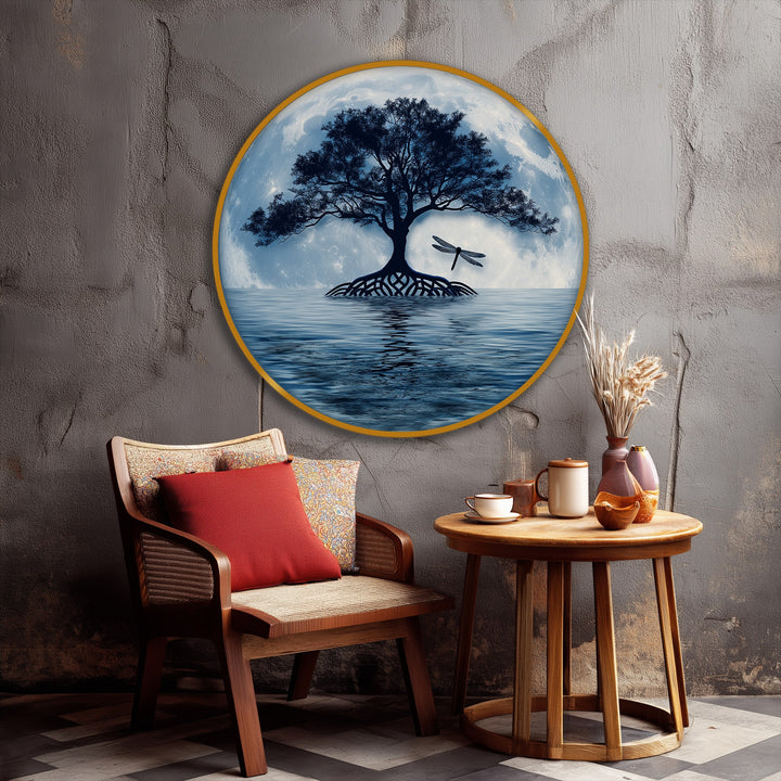 The darkest area highlights the silhouetted tree and dragonfly against the moon, a stunning focal point of this round canvas wall decor featuring a serene moonlit tree reflection.