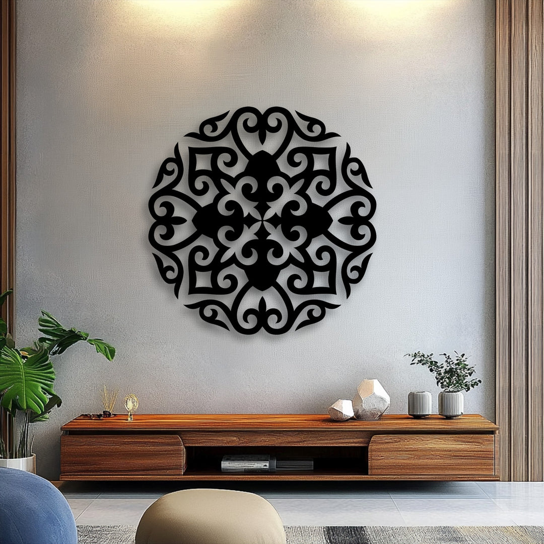 In the foreground, a sleek wooden media console displays geometric white vases and a vibrant plant, complementing the ornate metal artwork.
