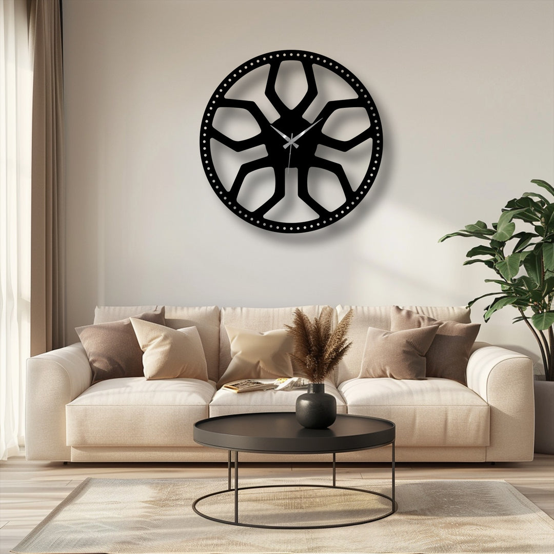 The sleek, matte black finish of the abstract radial pattern metal wall decor clock enhances its modern geometric design.