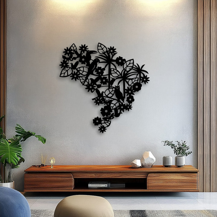 A light gray wall highlights a striking black silhouette metal artwork featuring an intricate floral bird garden design.