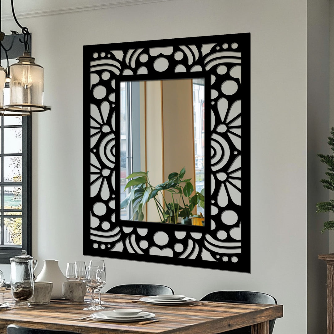 Intricate depth and layers are created in this art deco decorative mirror featuring a black metal frame with a repeating floral pattern and geometric detail.