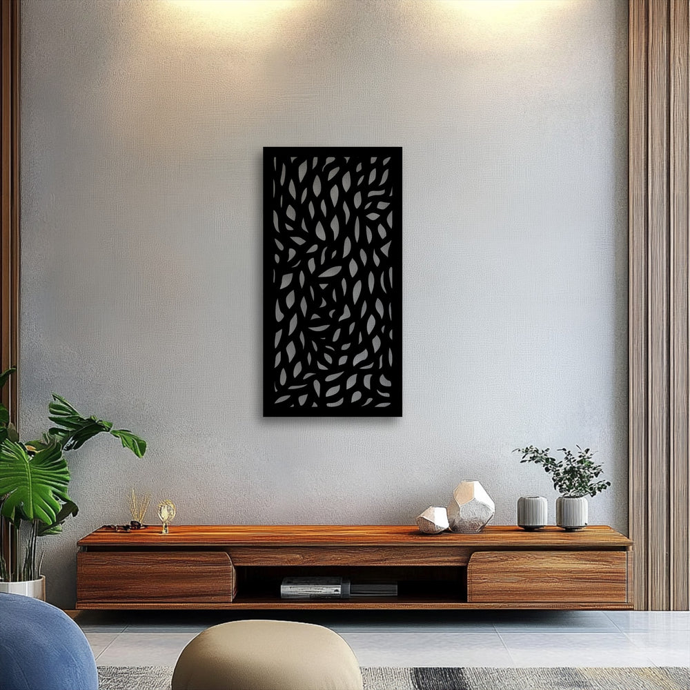 The stillness of the room is accentuated by the dark, abstract leaf pattern metal artwork hanging prominently above a simple wooden console.