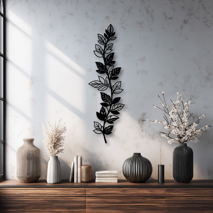 A serene and sophisticated mood is evoked by the sleek botanical leaf branch metal art for wall, casting gentle shadows in a stylish interior.