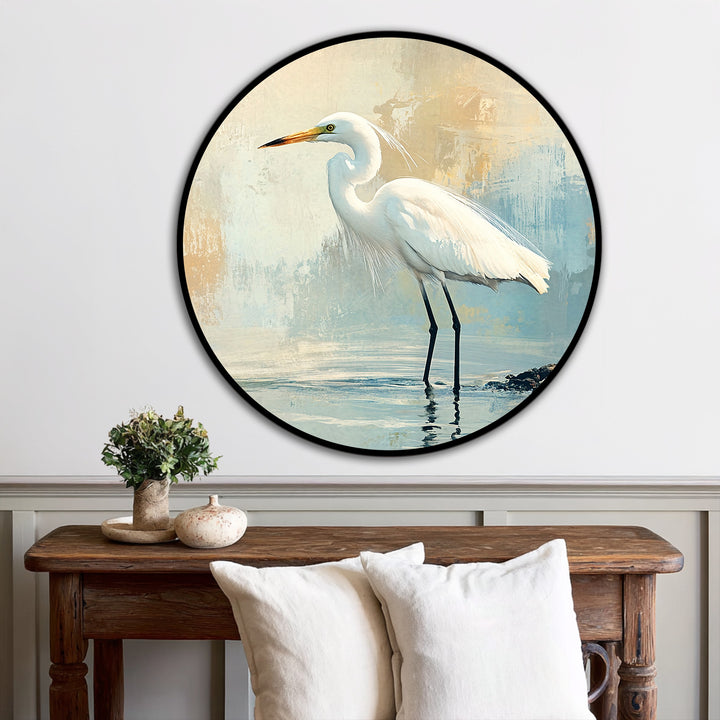 A serene mood evokes calm with this round, coastal oil painting reproduction print of a white egret wading in water, ideal home decor.