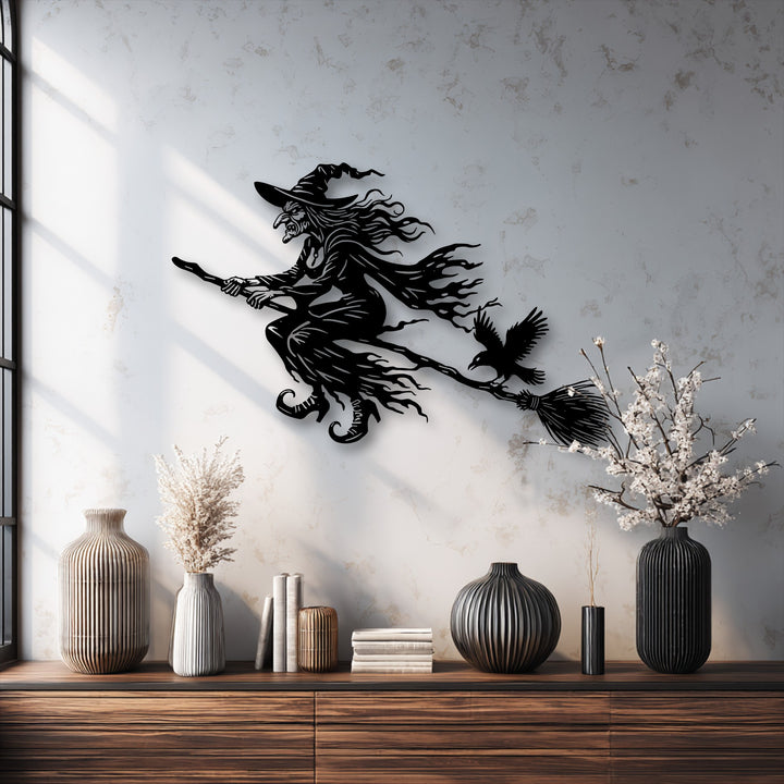 Horizontally oriented metal art for wall depicts a Flying Witch in an elongated shape, creating a striking Halloween dark decor piece.