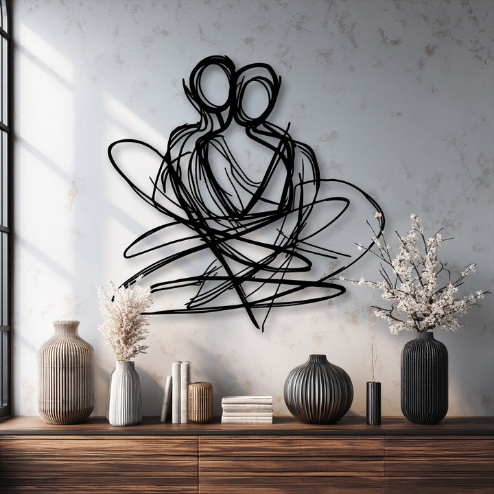 Subtly textured white wall with a distressed finish highlights the sleek black abstract couple metal art for wall, enhancing modern elegance.