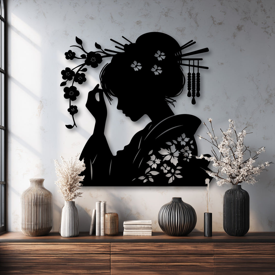 The brightly illuminated white wall highlights the elegant Geisha oriental silhouette metal wall art, a beautiful decoration wall art piece.