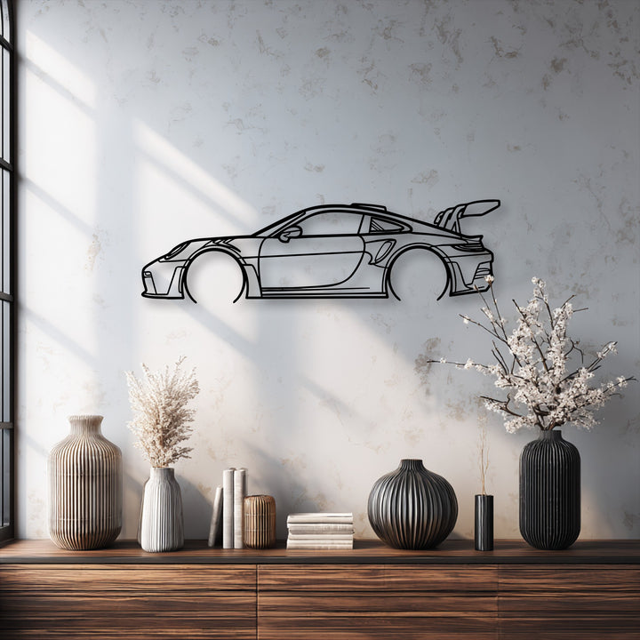 The mood of the minimalist sport car outline is striking against the textured wall, showcasing this modern automotive metal wall decor.