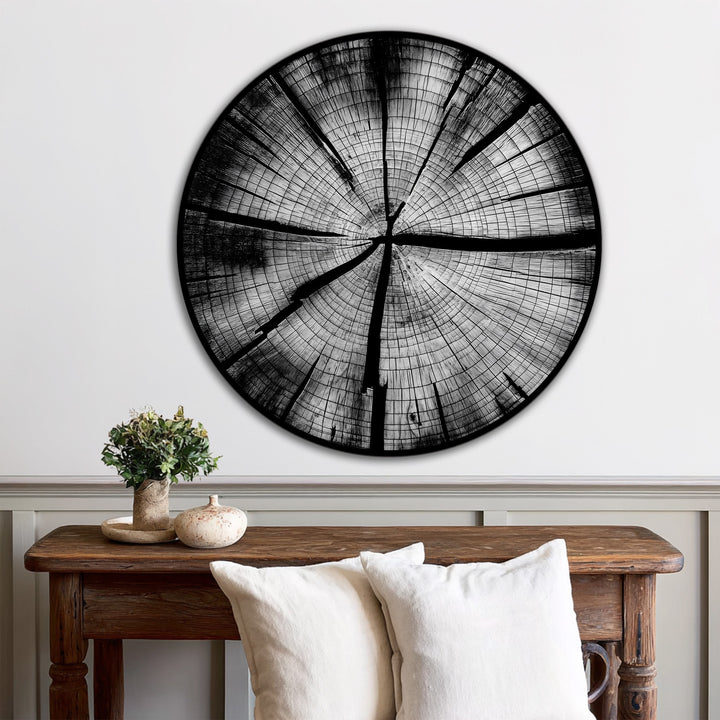 A simple white wall and wainscoting provide a stark contrast to the dark Monochrome Tree Rings oil painting art prints, adding depth to the minimalist decor.