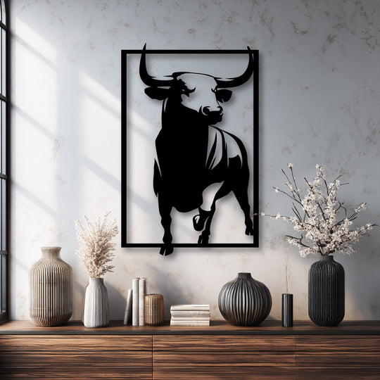 The abstract quality of this powerful bull metal art for wall is highlighted by its bold, silhouetted design within a rectangular frame.
