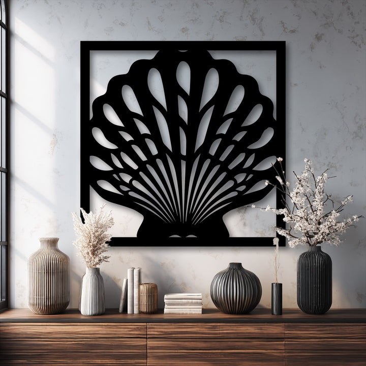 The gritty surface texture of the wall highlights the sleek unique metal wall art, elegant seashell frame, and ribbed vases.