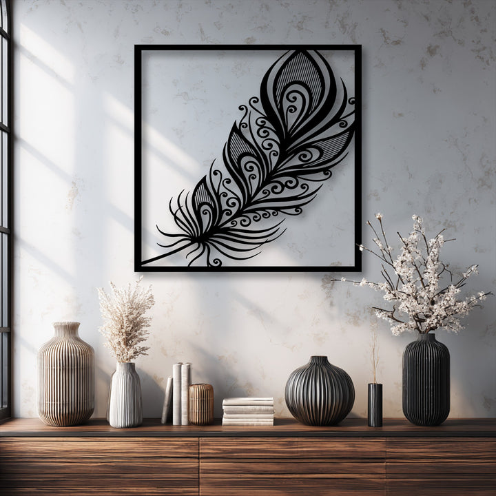 An off-white textured wall showcases an intricate black ornate feather metal art for wall, providing elegant plume decor.