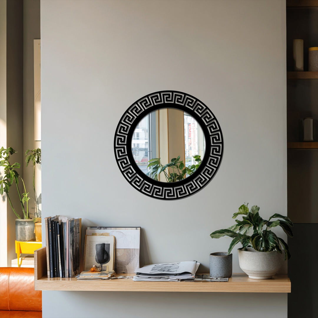 Highlighting the layering effect, the round mirror features a Greek key pattern, presenting a stained glass wall mirror appearance within the modern black frame design.