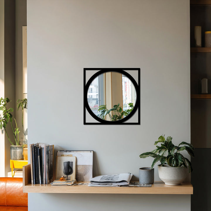Featuring the layering effect of a modern round bathroom mirror framed by a bold black metal square outline, enhancing depth and visual interest.