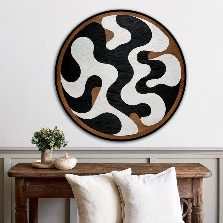 Encircling monochrome fluid shapes, the black edge highlights a thin band of brown in this round abstract oil painting artwork, creating defined borders on the minimalist piece.