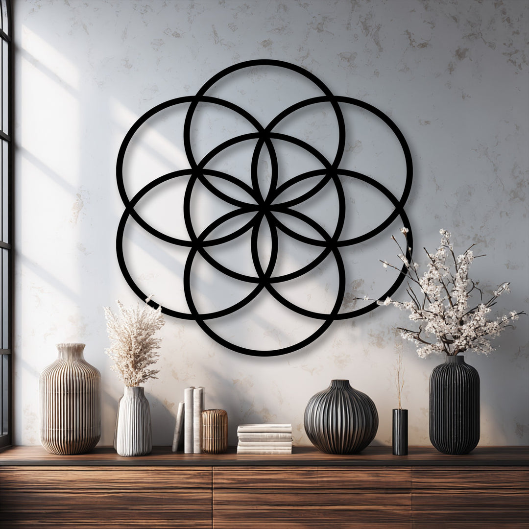 The transition between the bold black Sacred Balance Flower of Life decoration wall art and the subtle textured white wall creates a striking contrast.