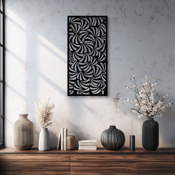 An intricate black and silver decorative metal art panel features a dynamic spiral flow abstract pattern, serving as the room's central focal point.