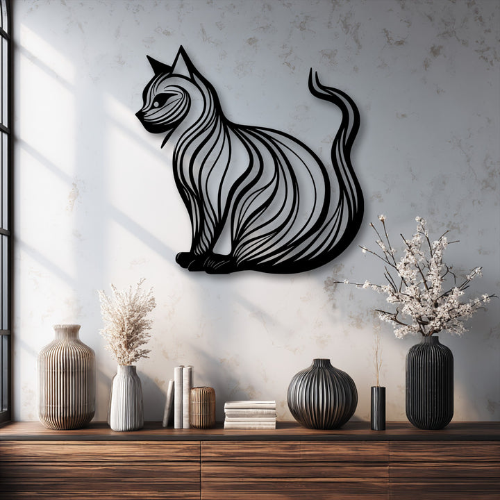 Exhibiting striking depth, the elegant cat silhouette metal art for wall casts shadows, layered above varied decor on a rich wooden surface.