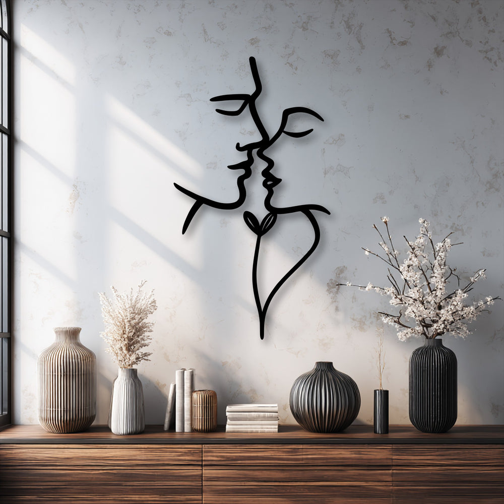 The brightest area features a sun-drenched, textured white wall showcasing a striking abstract lovers decorative metal art piece.